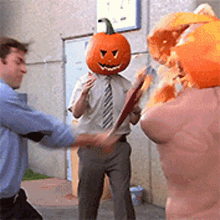 a man with a pumpkin head is fighting another man with a pumpkin head