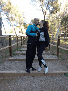 a man and a woman kissing on a set of stairs