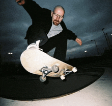 a man wearing glasses is riding a skateboard