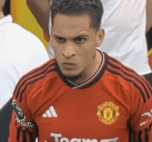 a man wearing a red jersey with the word team on it