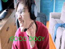 a man wearing headphones and glasses says good dogy in green letters