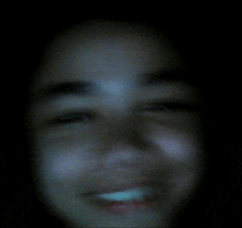 a blurry picture of a person 's face with a smile