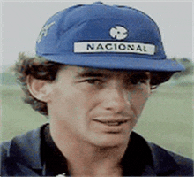 a man wearing a blue hat that says nacional on it .