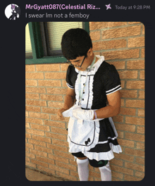 a man dressed as a maid is standing in front of a building