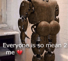 a robot with a huge butt is standing in a bathroom with a broken heart .