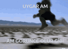 a blurred image of a person running in the desert with the words uygaram am gorunca olur gibi