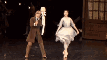 a man and a woman are dancing on a stage in a ballet