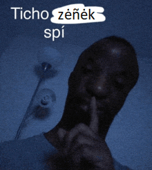 a man holds his finger to his mouth with the words " ticho zenek spi " above him