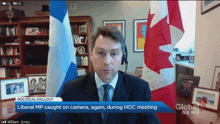 a man in a suit and tie is sitting in front of a screen that says global news