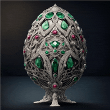 a silver egg with emeralds ruby and diamonds