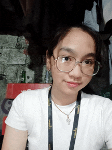 a young woman wearing glasses and a lanyard that says cobra