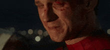 a close up of a man 's face with blood on his face .