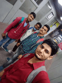 a group of young men are posing for a picture in front of a sign that says ' do not enter '