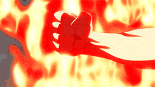 a fist is being held up in front of a wall of flames