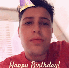 a man wearing a party hat with the words happy birthday written on it