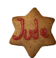 a star shaped cookie has the name jude written on it