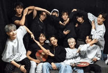 a group of young men are posing for a picture and making a heart shape with their hands