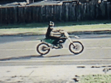 a person riding a bike with the letter g on the front