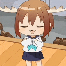 a girl with antlers on her head is standing on a wooden floor with her arms crossed .