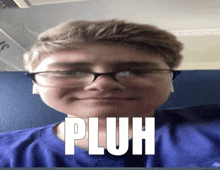 a young boy wearing glasses and a blue shirt with the word pluh on his face