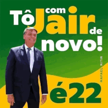 a man in a suit and tie stands in front of a green and yellow sign that says com tojair de novo e22