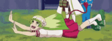 a girl with green hair and a red tail is laying on her back in the grass .