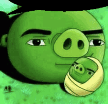 a green angry birds character is holding a baby pig in its mouth .