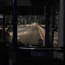 a bus is driving down a highway at night with a sign that says ' emergency exit ' on it