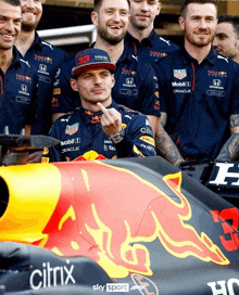 a man wearing a red bull shirt giving the middle finger