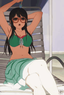 a girl in a green bikini sits in a chair with a lollipop in her hand