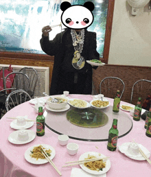 a panda bear stands in front of a table full of food and bottles of budweiser