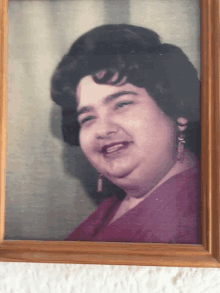 a picture of a woman in a purple dress is framed