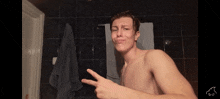 a shirtless man is making a funny face while pointing at himself