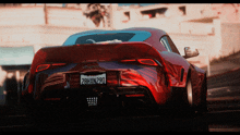 a red sports car with a california license plate that reads 28hxn290