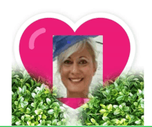 a picture of a woman in a blue hat is in a pink heart