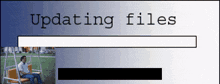 a man is sitting on a swing with the words updating files behind him