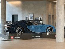 a lego technic car is displayed in a room