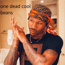 a man with a bandana on his head and the words one dead cool beans