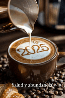 a cup of cappuccino with the year 2025 written on the foam