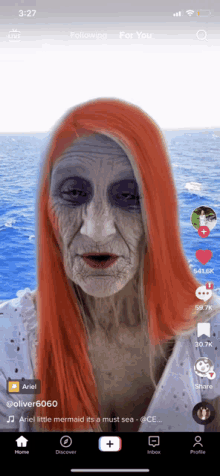 a screenshot of the tiktok app shows a woman with red hair