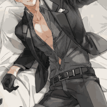 a man in a suit is laying on a bed without a shirt .