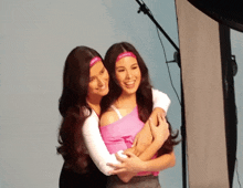 two women hugging each other with one wearing a headband that says ' ariel ' on it