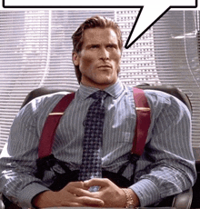 a man wearing suspenders and a tie is sitting at a desk