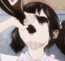 a girl is drinking from a bottle with her nose .