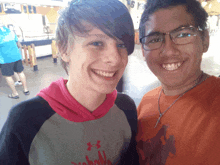 a boy wearing an under armour shirt smiles for the camera