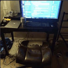 a desk with a computer and a chair on it