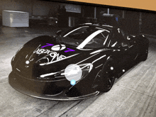 a black sports car with a purple sticker that says xboxone