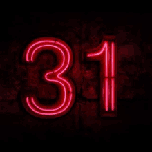 a neon sign that says the number 31 on a black background .