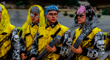 a group of people wearing yellow jackets with skulls on them are holding bats