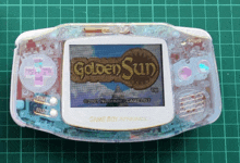 a game boy advance displays a golden sun game